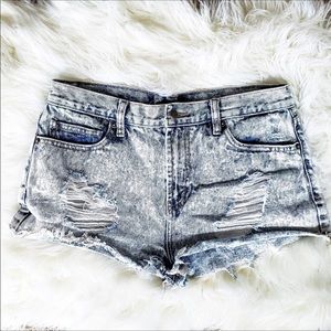 A pair of acid washed distressed style shorts